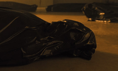 a pile of black bags sitting on top of a floor