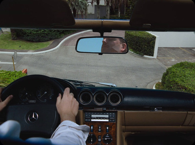 a man driving a car down a street