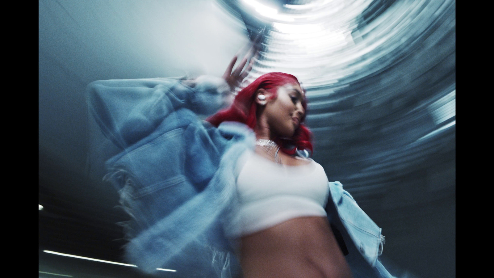 a woman with red hair is dancing in a room