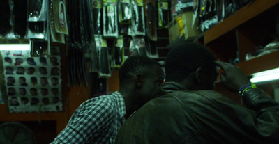 a couple of men standing next to each other in a store