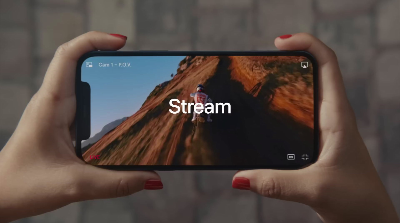 a person holding a cell phone with the stream app on the screen