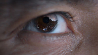 a close up of a person's eye with a blurry background