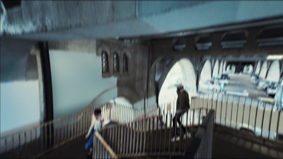 a blurry image of people walking down a set of stairs