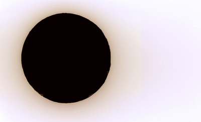 a black circle in the middle of a white wall