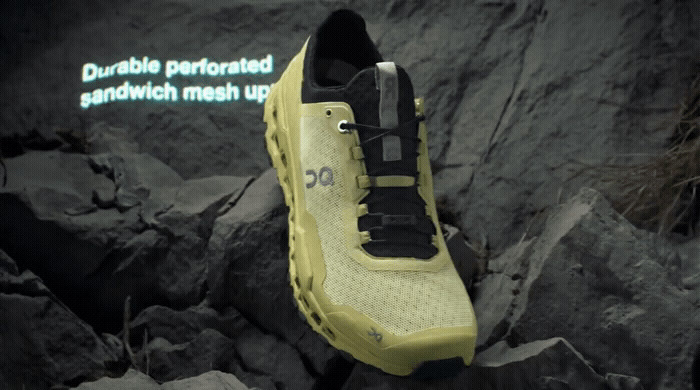 a pair of yellow and black shoes on a rock