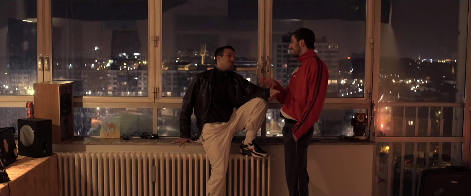 a couple of men standing on top of a window sill