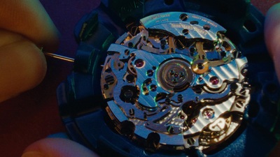 a close up of a person holding a watch