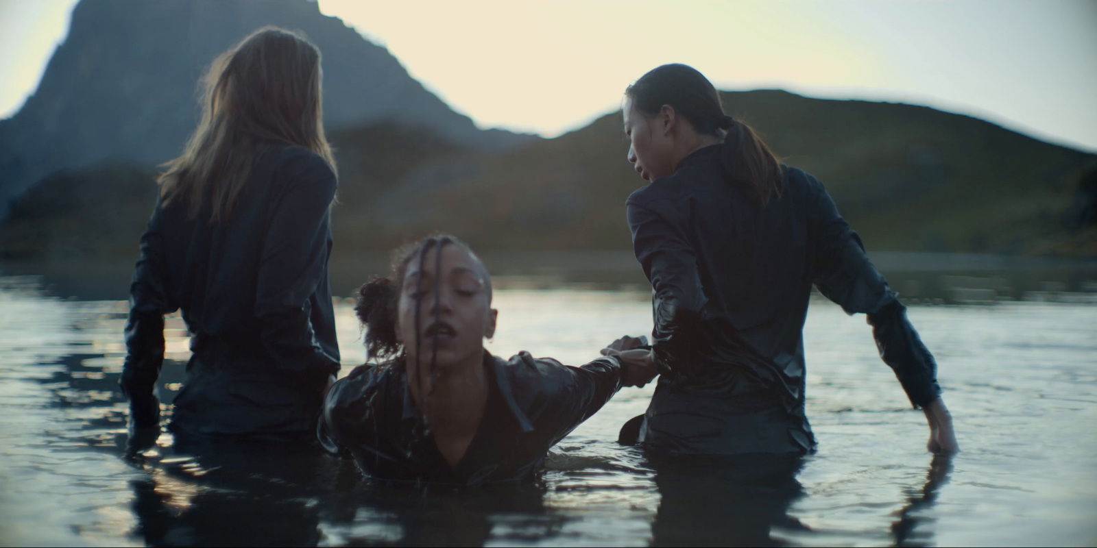 a group of people standing in a body of water