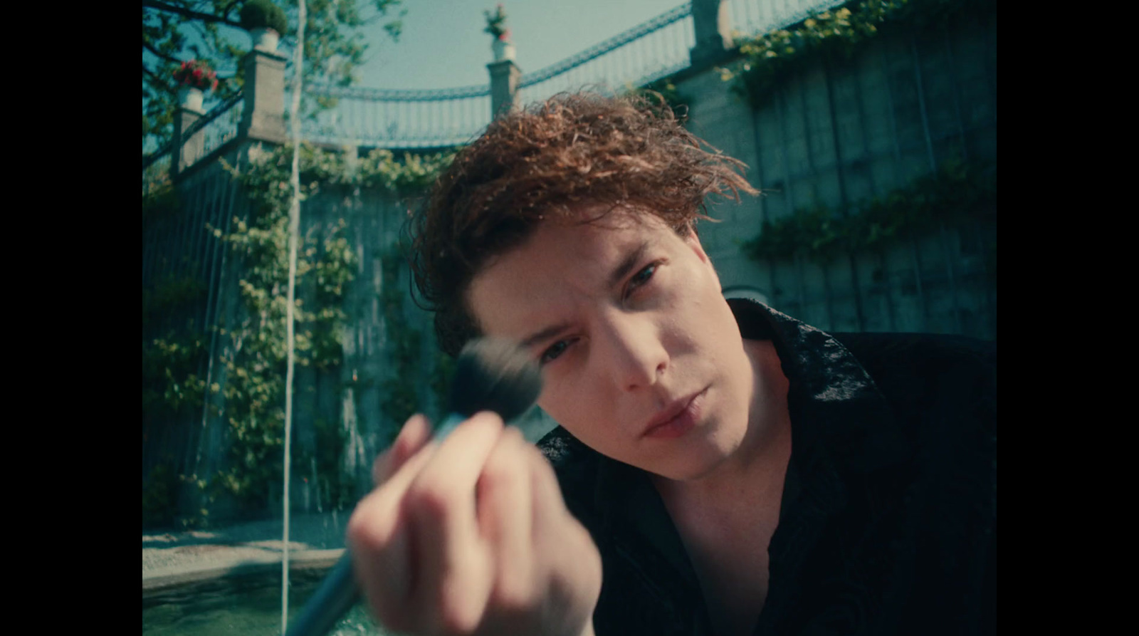 a young man holding a toothbrush in his hand