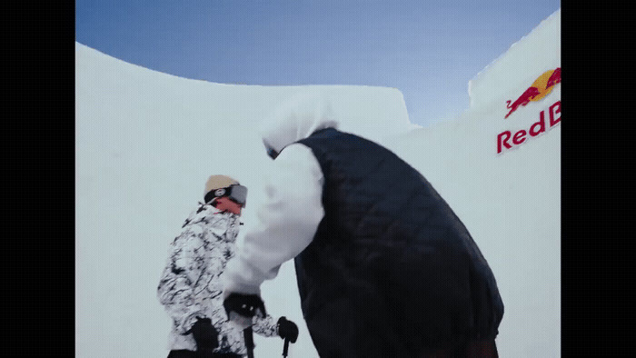 a man standing on top of a snow covered slope