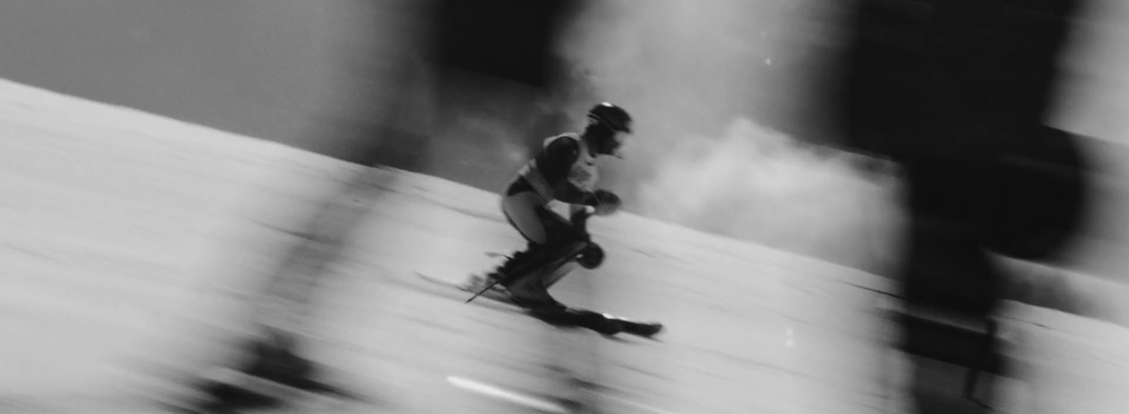 a man riding skis down a snow covered slope