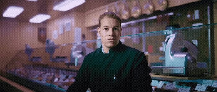 a man standing in front of a counter in a store