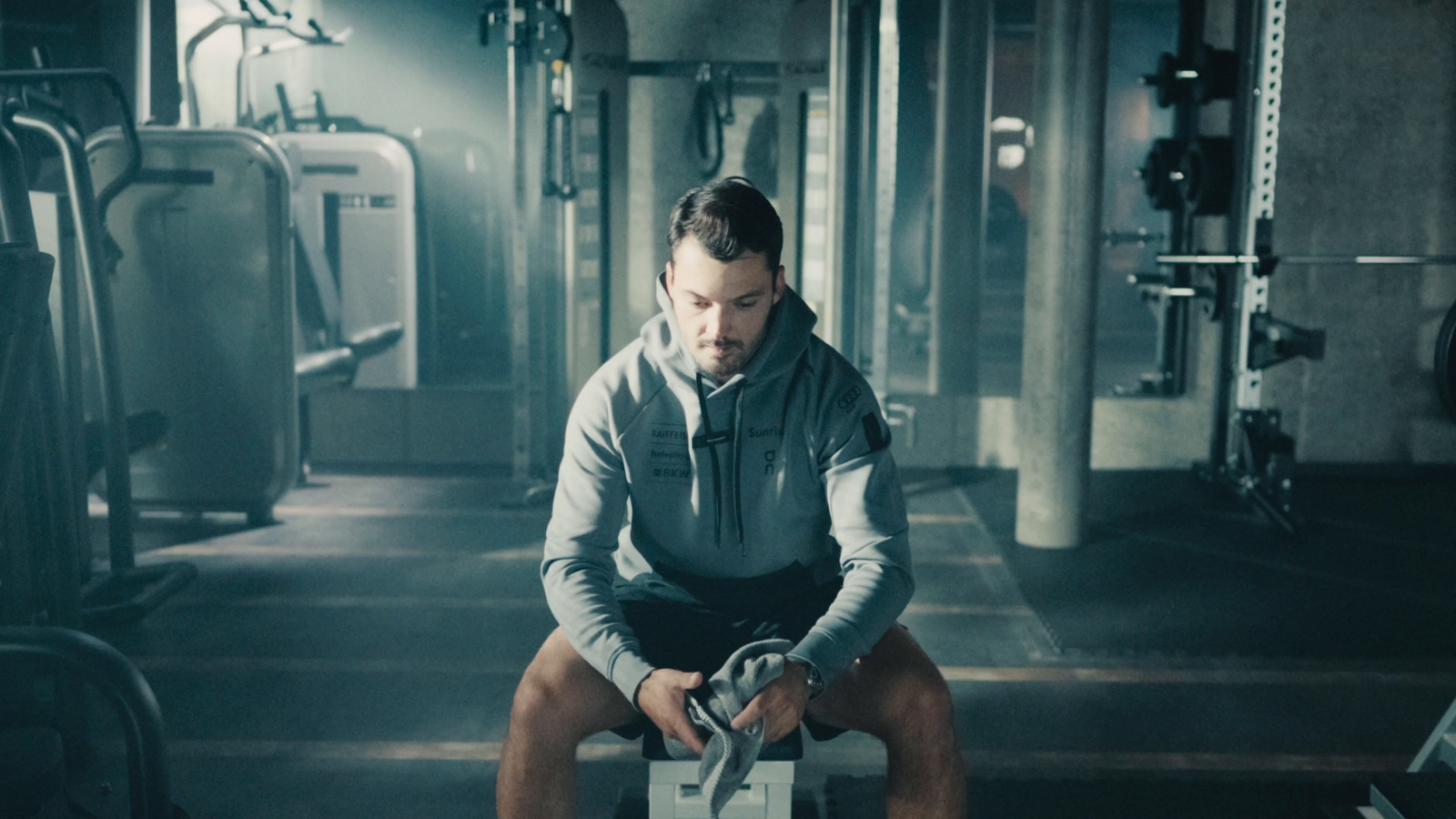 a man sitting on a bench in a gym