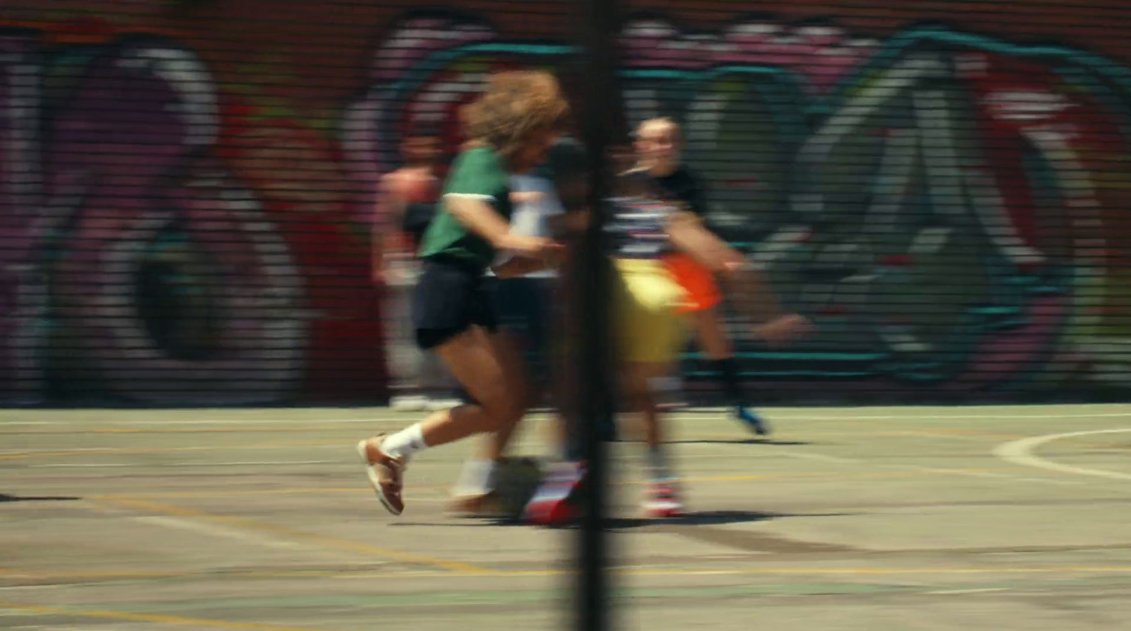 a group of people playing a game of basketball