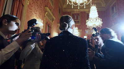 a group of people standing around each other in a room