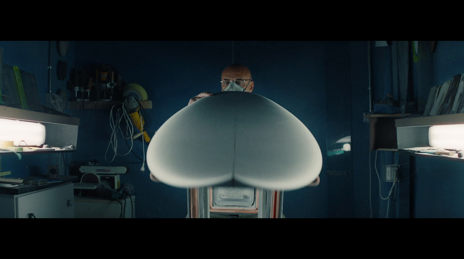 a man standing in a kitchen under a light