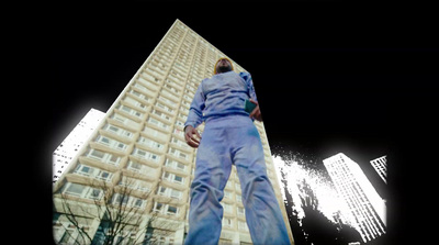 a man standing in front of a tall building