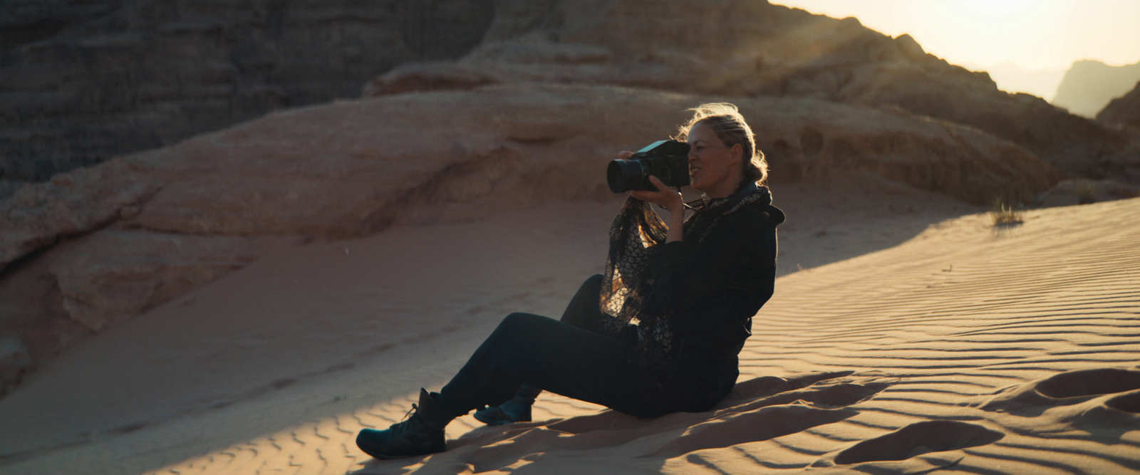 a woman taking a picture of herself in the desert