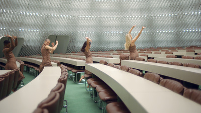 a group of people standing in front of a room filled with chairs