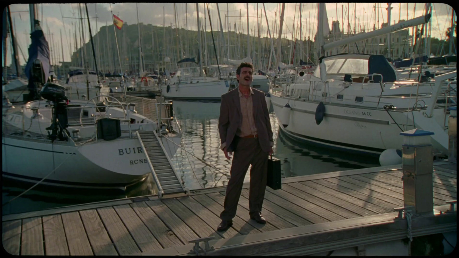 a man standing on a dock next to a bunch of boats