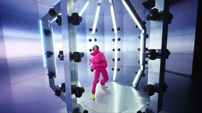 a woman in a pink suit standing in a room