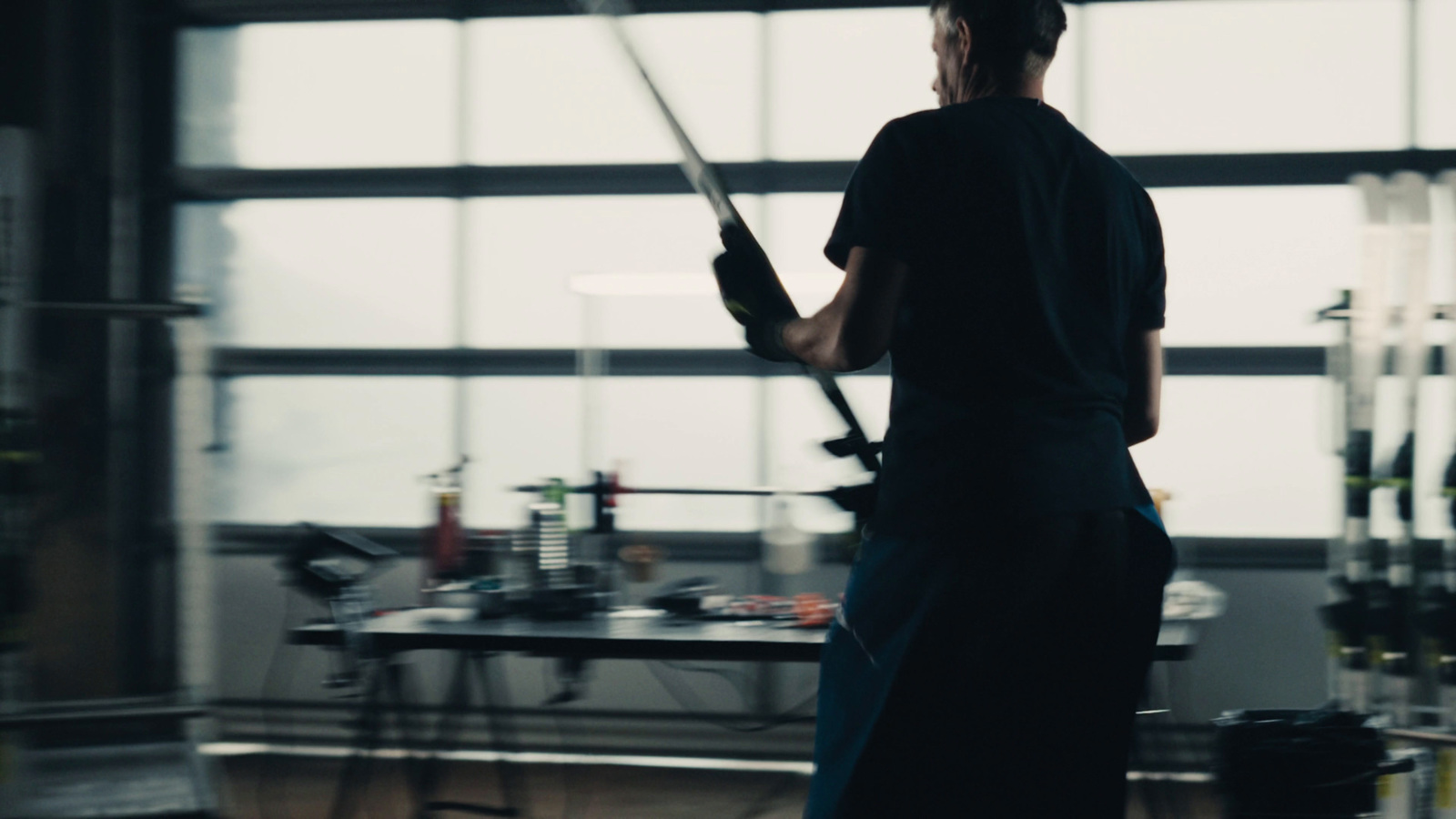 a man holding a large sword in a room