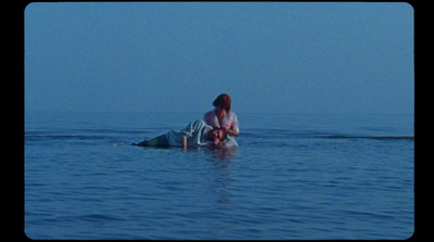 a woman sitting on a surfboard in the ocean