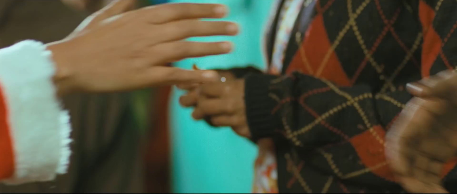 a close up of two people holding hands