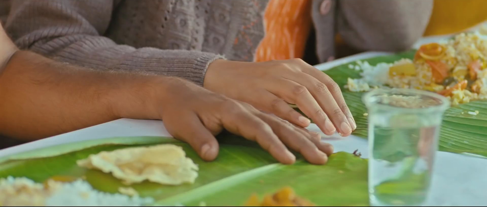 a close up of a person sitting at a table with a plate of food