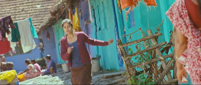 a woman standing in front of a blue building