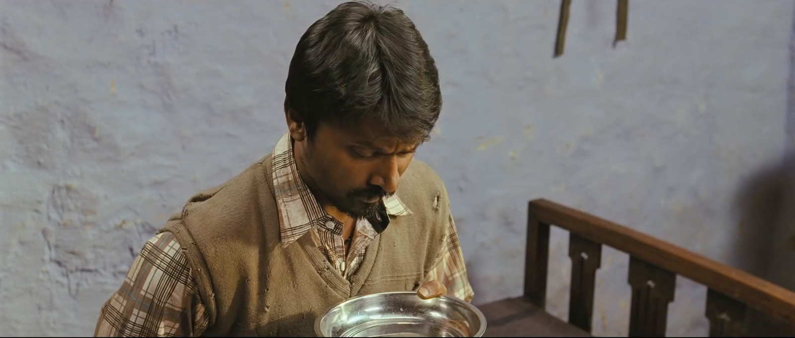 a man holding a bowl of food in his hands