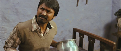 a man standing next to a metal pot