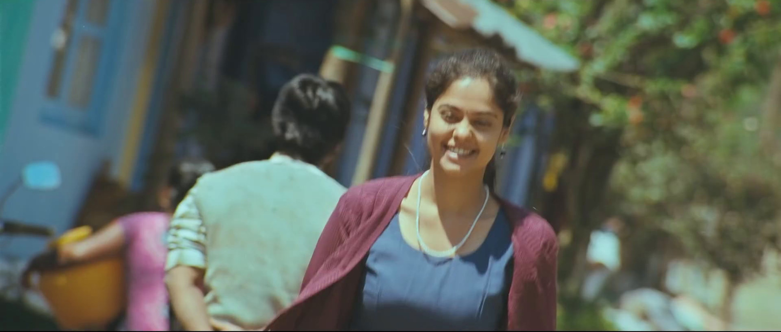 a woman walking down a street with a smile on her face