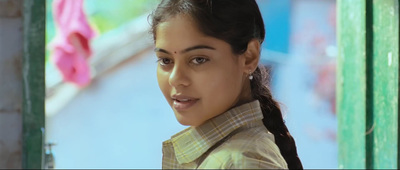 a woman with a ponytail standing in front of a wall