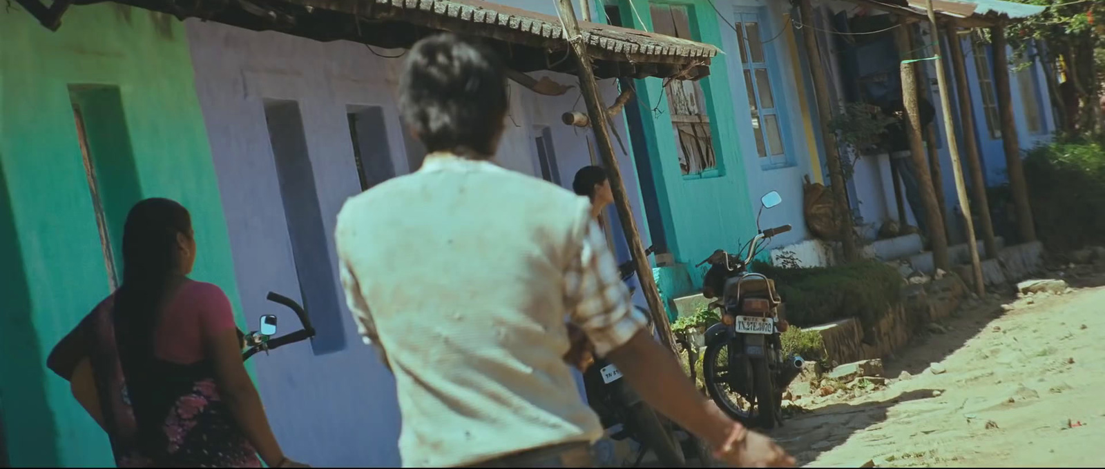 a man walking down a street next to a woman