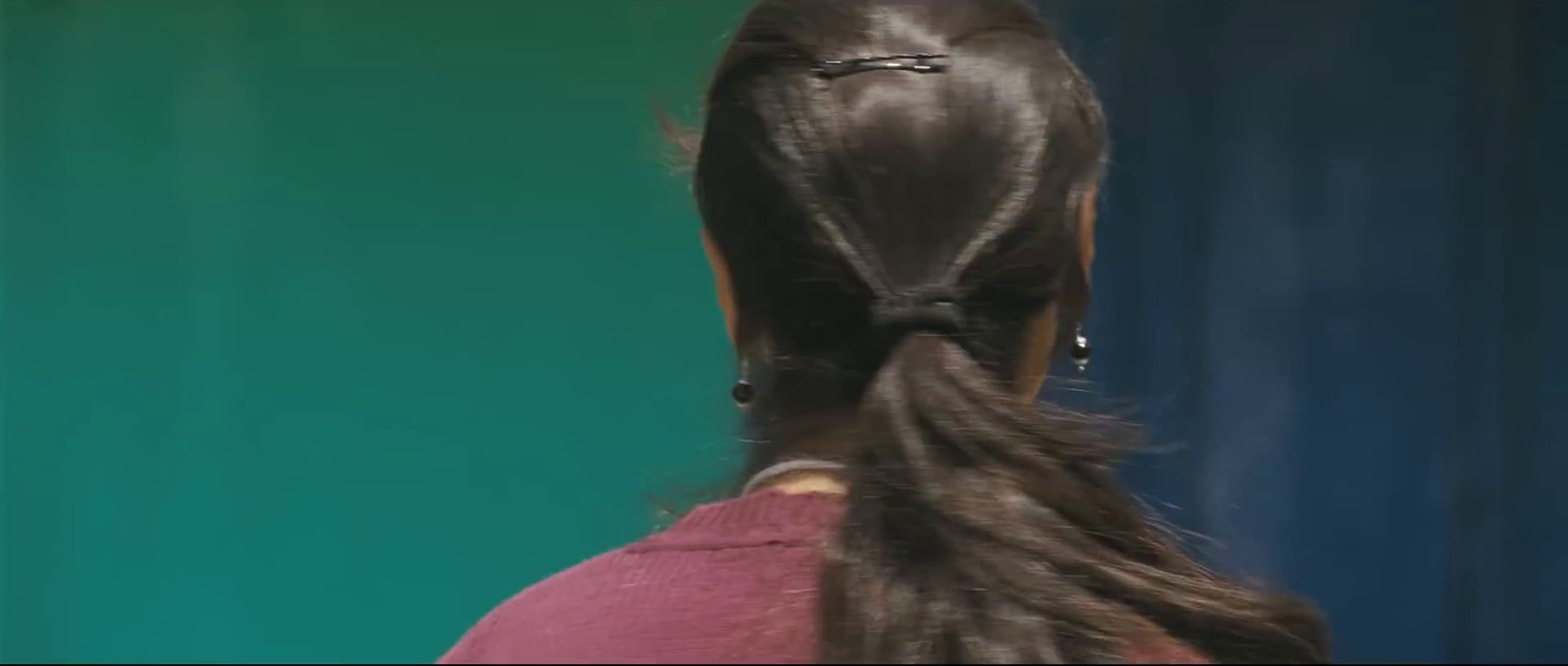 a woman with long hair in a ponytail