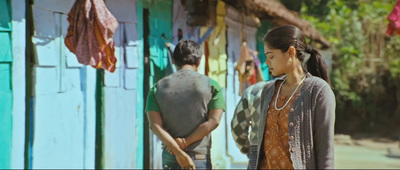 a woman standing in front of a colorful building