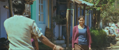 a woman walking down a street next to a man