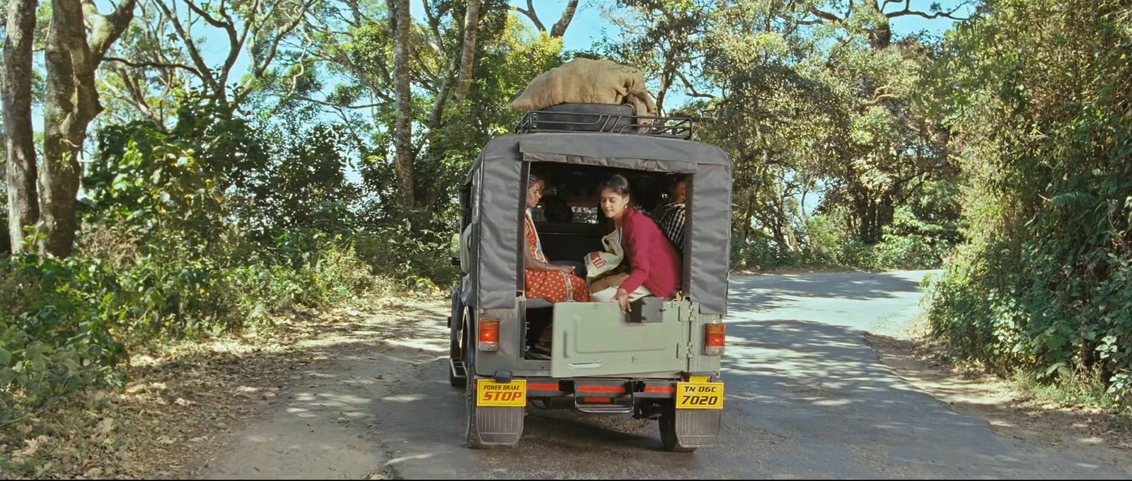 a couple of people riding in the back of a truck