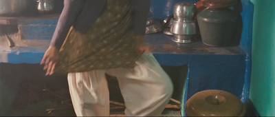 a woman standing in a kitchen next to a stove