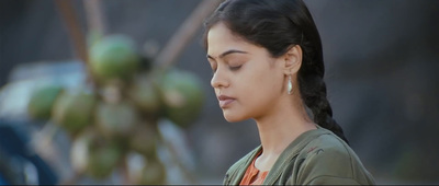 a woman with her eyes closed standing in front of a tree