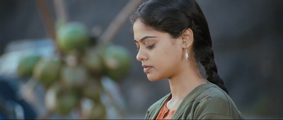 a woman with her eyes closed standing in front of a tree