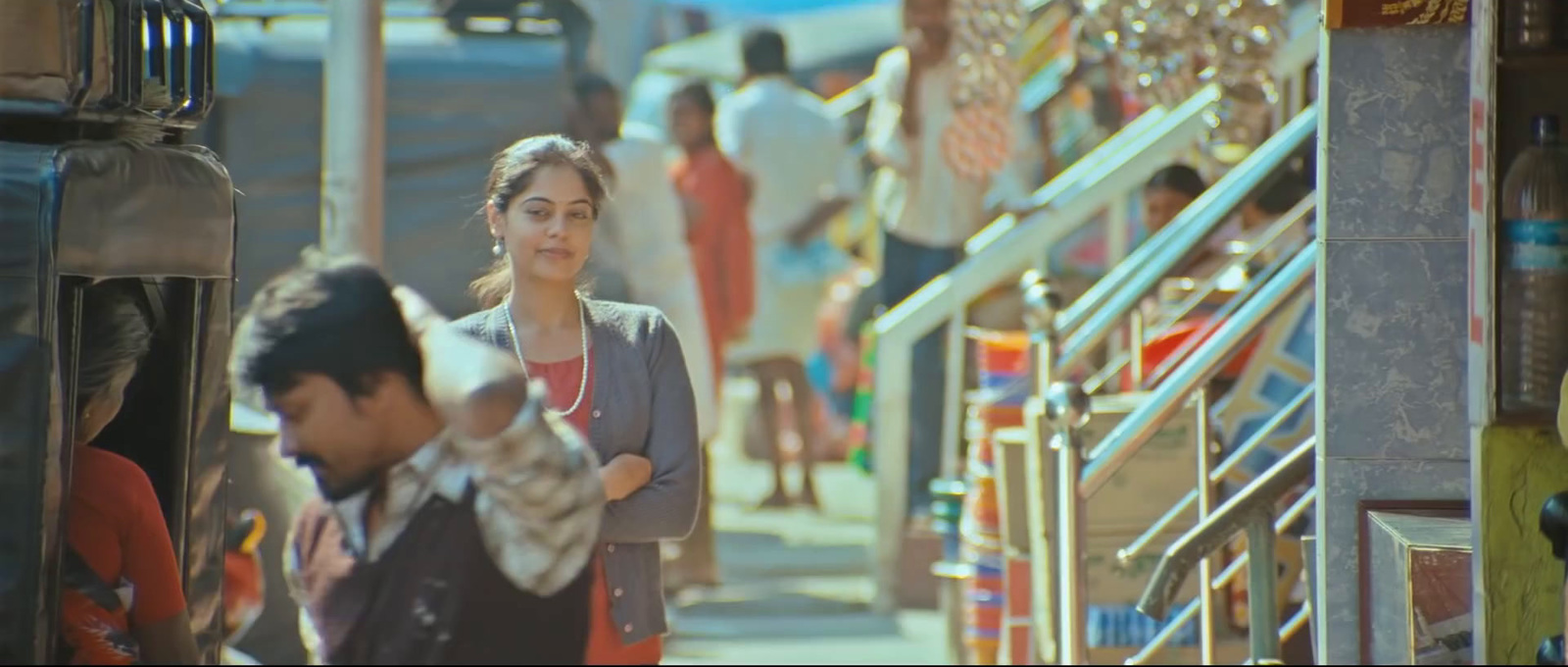 a woman standing next to a man on a street