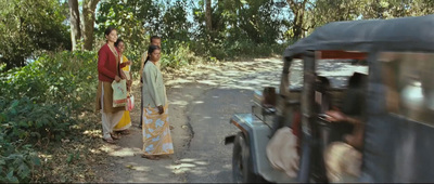 a couple of women walking down a dirt road