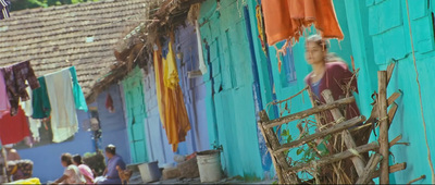 a woman standing on a ladder in front of a building