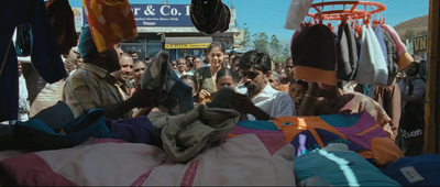 a crowd of people standing around a pile of clothes