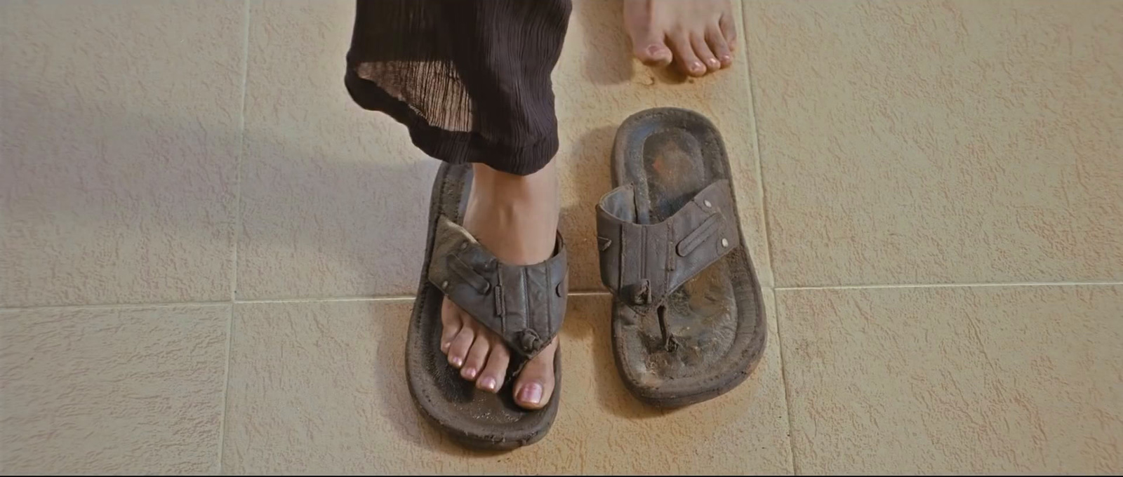 a person standing on top of a pair of sandals