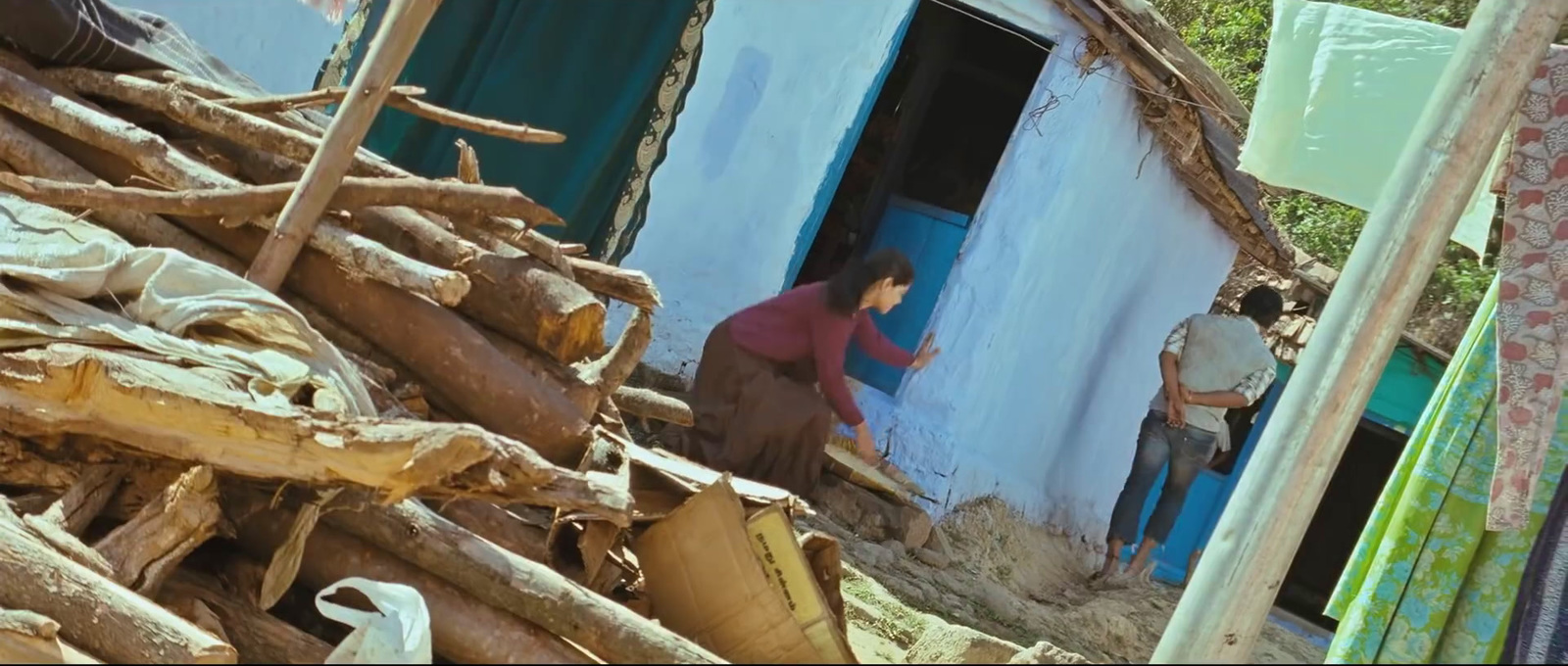 a couple of people standing outside of a house