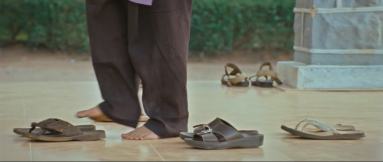 a person standing next to two pairs of shoes