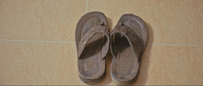 a pair of shoes sitting on top of a tiled floor